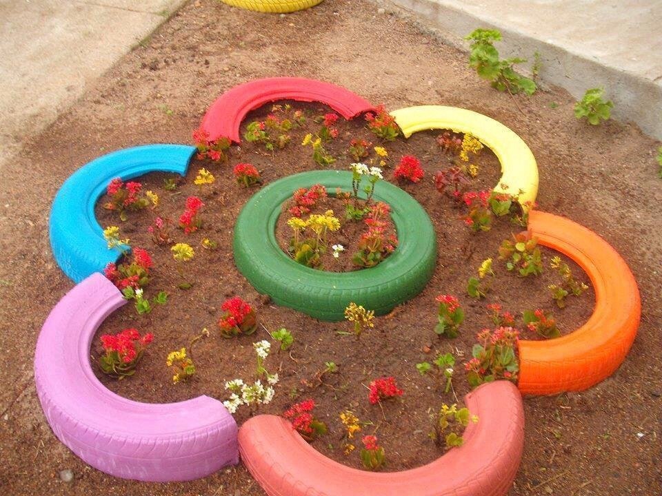 Bright flower bed of old tires on the site