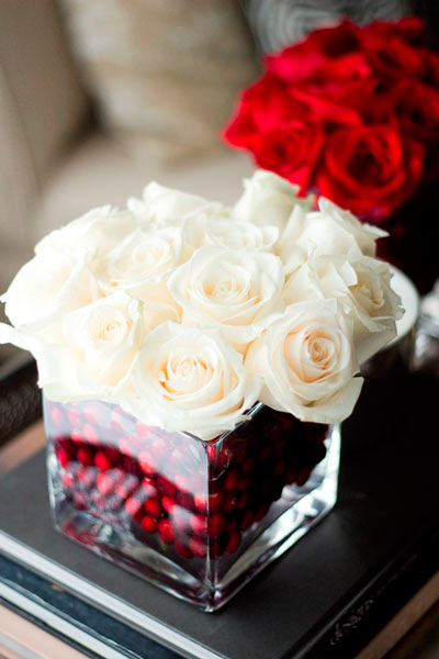 Floral center with white and red roses and blueberries at the base.