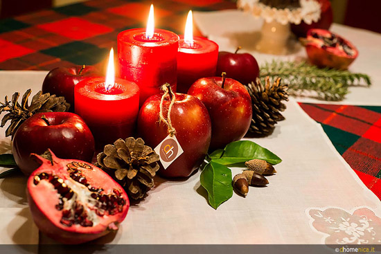 Homemade Christmas center with apples, pomegranates, acorns and wild pineapples.