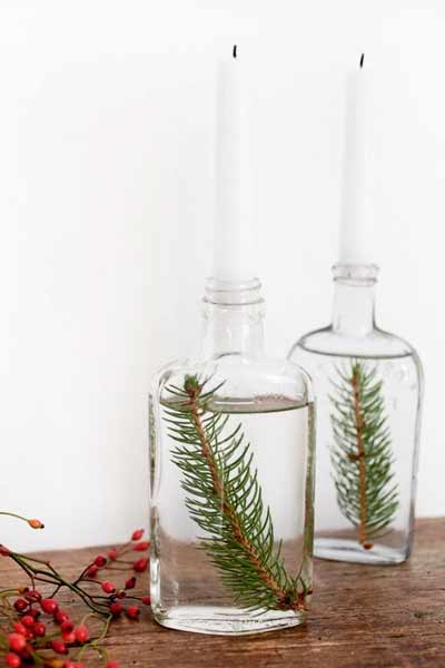 Large glass bottles with a pine leaf and a candle.