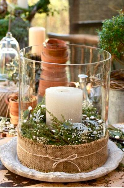 Simple glass vase to decorate the table with a candle and Christmas plants.