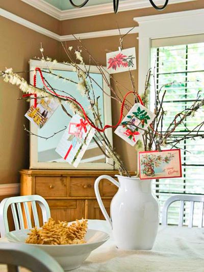 Vase with branches and Christmas postcards.