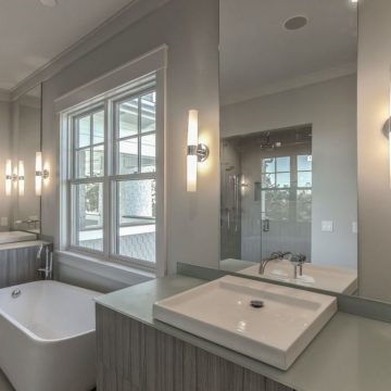 Kohler sinks with glass countertops and floating twin vanities. Pic by lorrainegvaledesign