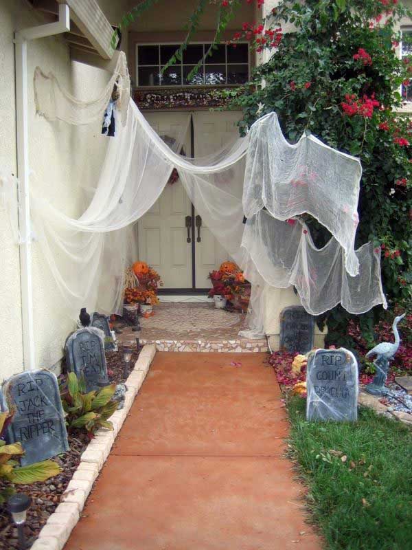 Artificial spider and tombstones turn the yard into a graveyard.