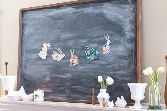 Simple Easter spring mantel with floral bunny chalkboard garland.