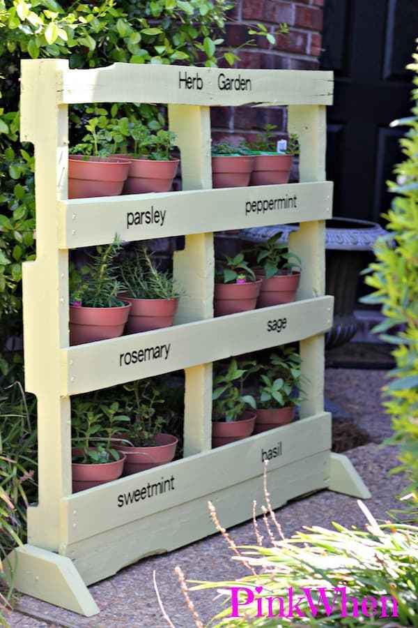 Standing planter that holds terra cotta planters.