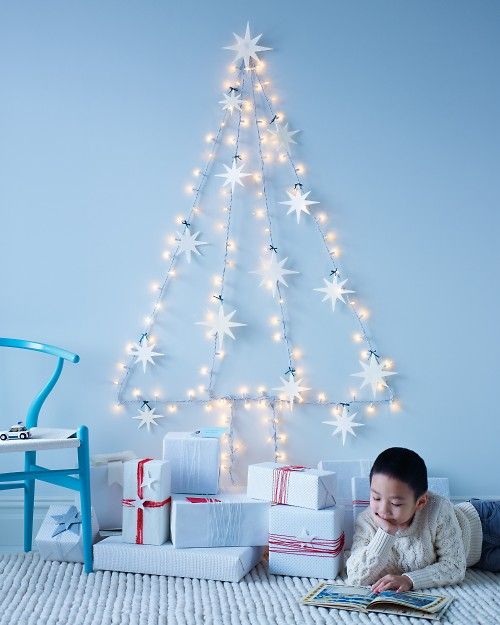 Amazing string light wall tree with felt ornaments for small space.