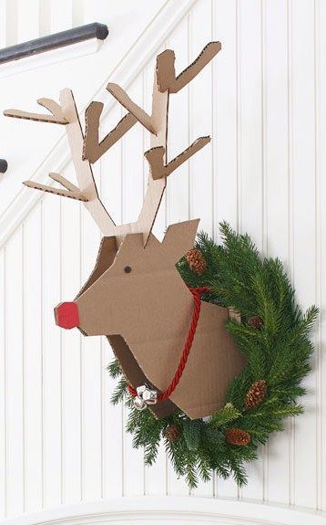 Cardboard reindeer with fresh wreath.