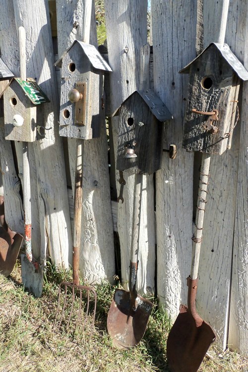 Create a birdhouse city with old rakes and shovels.