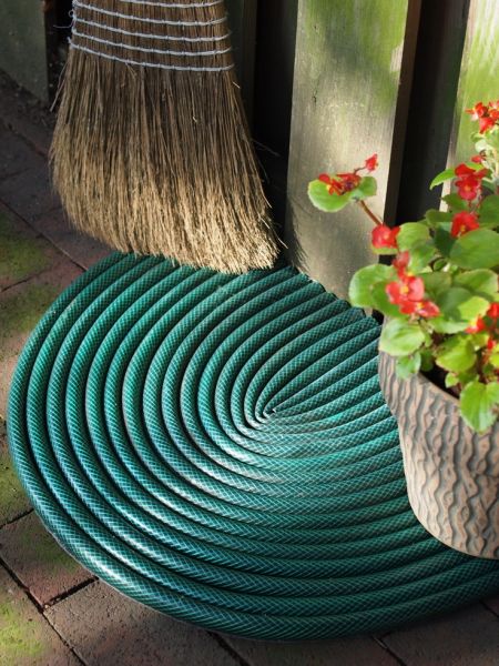 Create a custom door mat from a leaky garden hose.