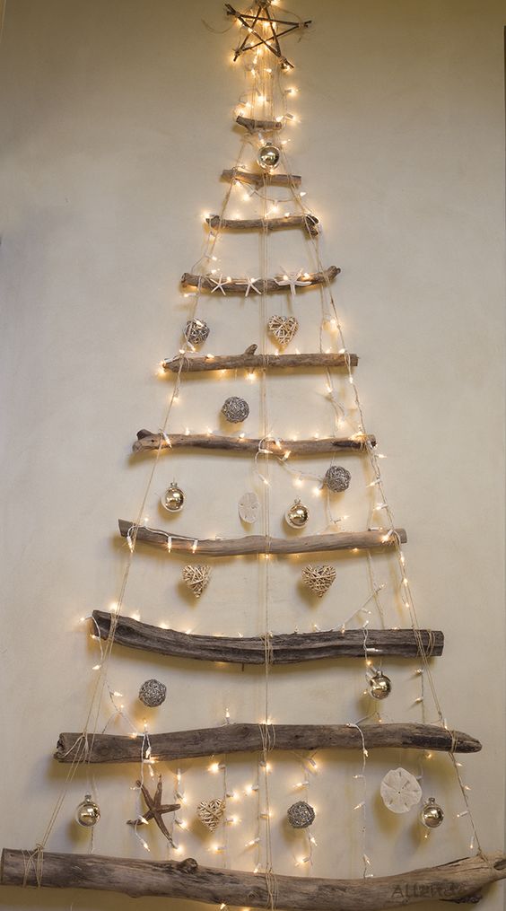 Dashing rope ladder Christmas Tree idea decorated with silver and golden ornaments with lights.