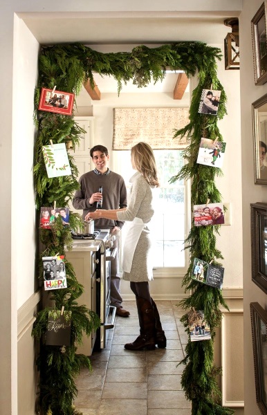 Door is decorated with garland and photos.