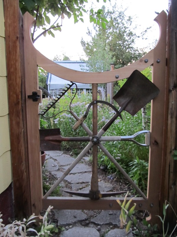 Garden gate made with repurposed garden tools.