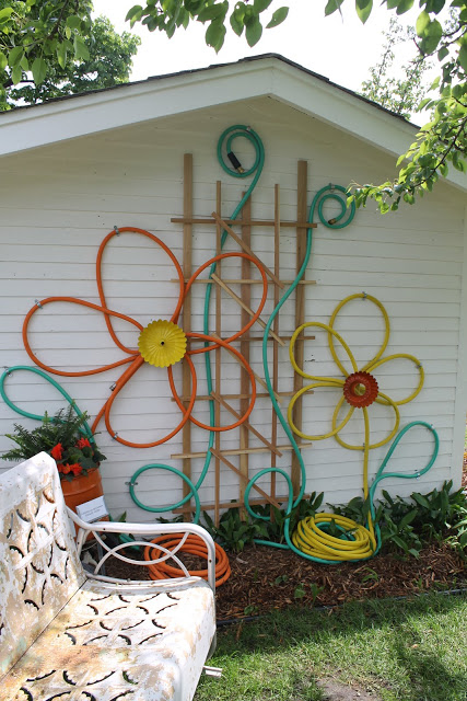 Garden hose and bundt pans turned into flowers.