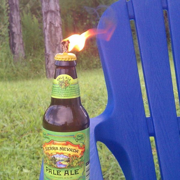 Glass Beer Bottle Tiki Torch for Backyard Barbecue.