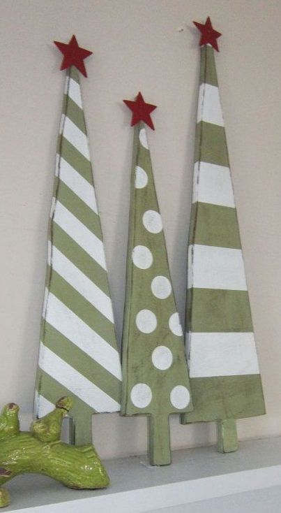 Little green and white wooden Christmas tree with red star tree topper.