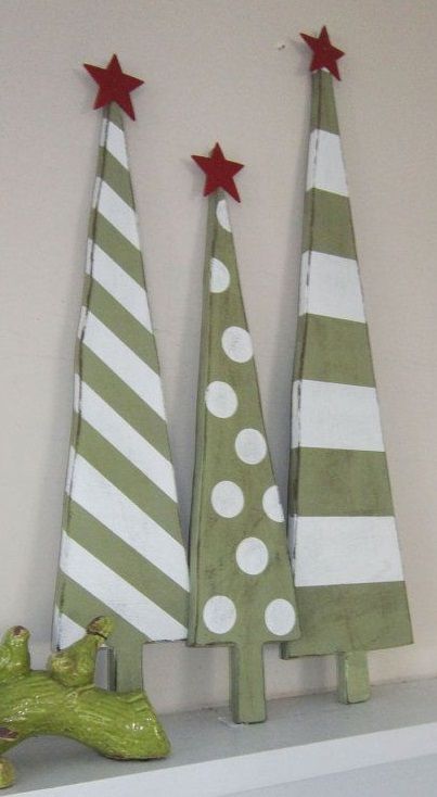 Little green and white wooden Christmas tree with red star tree topper.