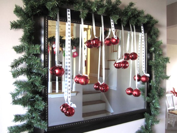 Mirror is decorated with garland and red ornaments.