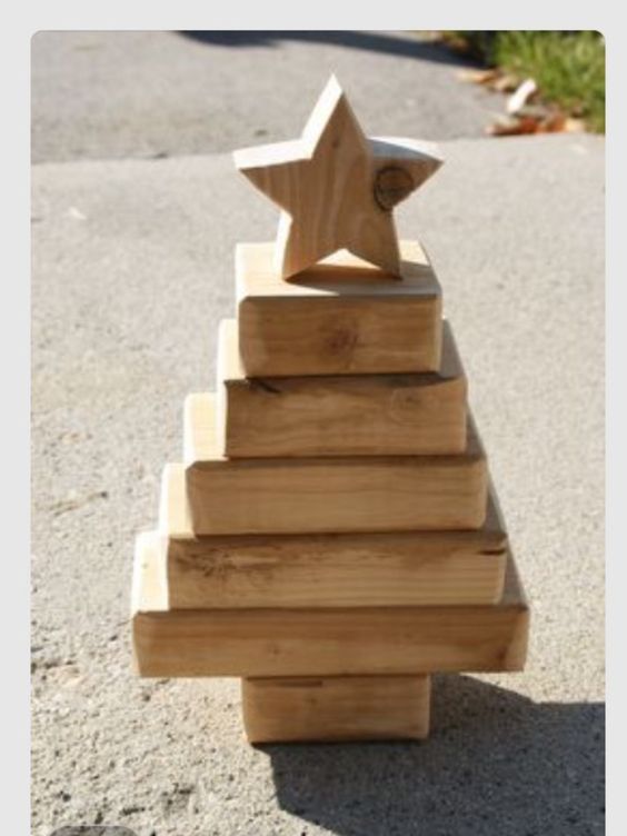 Raw wooden box arranged as Christmas tree with star.