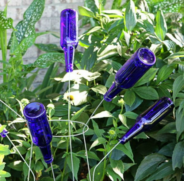 TOMATO CAGE BOTTLE TREE made with blue beer bottles.