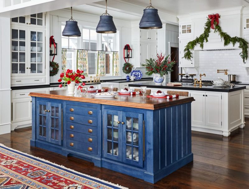 Blue painted cabinets and kitchen decorated for chistmas holiday.