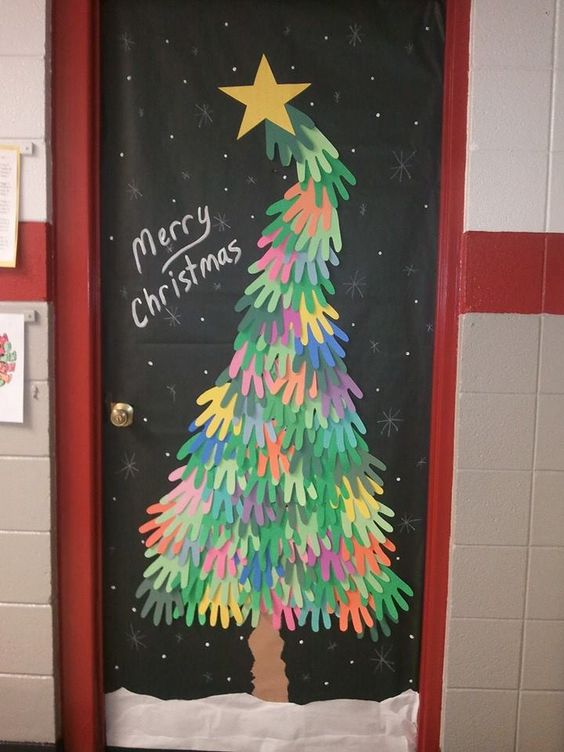 Handprint paper cutout Christmas tree on door.