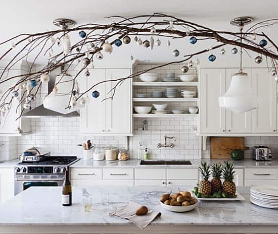 Natural branches are hung in kitchen ceiling with florist’s wire.