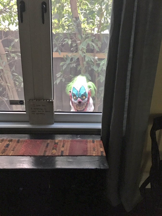 Creepy clown peeking in window