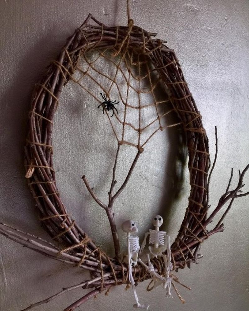 Grapevine Wreath with Spider Web and Skeletons Sitting.