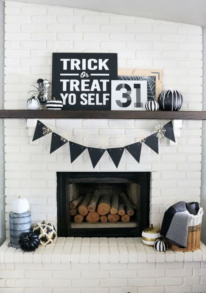 Super cute mantel setup with only black items.