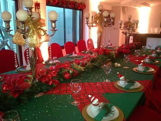 Christmas feast with table settings dressed and centerpieces to celebrate the season.