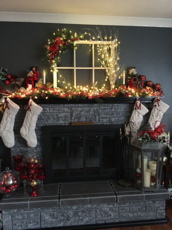 Christmas mantle with sweater stockings and vintage window.