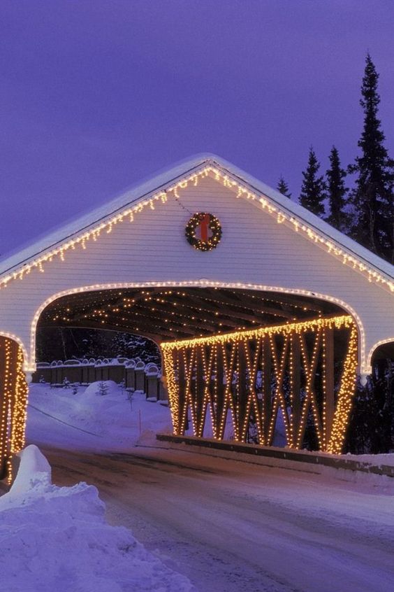 Covered bridge with holiday lights.