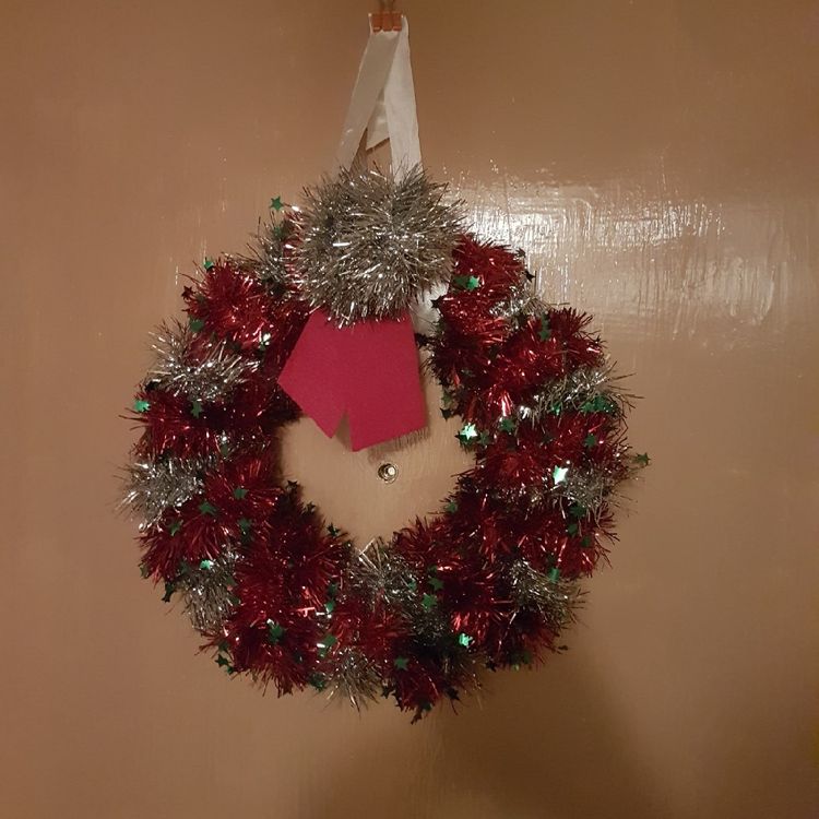 Done using cardboard circle, cushion stuffing, felt wrapping then red and silver tinsel.