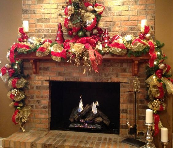 Fireplace - started with a lighted garland, added gold and red ribbon, large ornaments wired together, two candle sticks decorated with ribbon and ornaments.